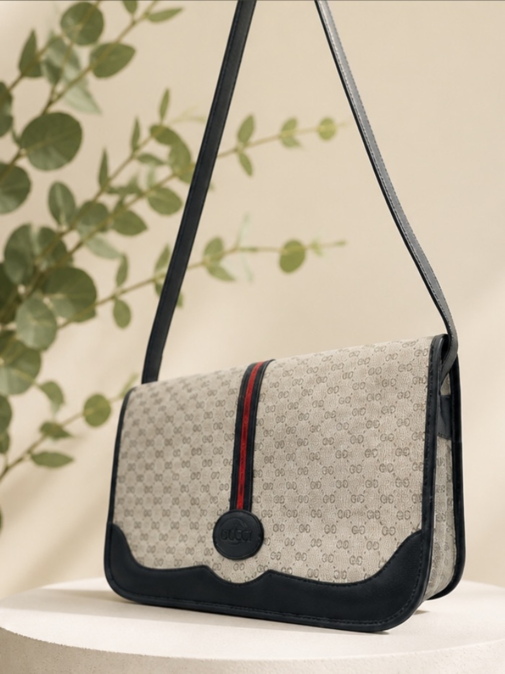 Gucci Grey GG Supreme crossbody with Black trim and red-blue stripe.